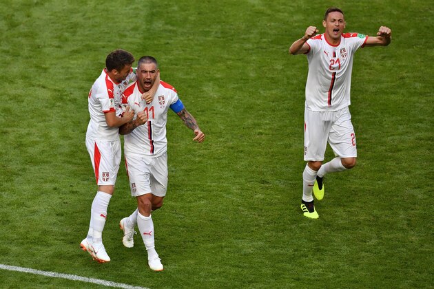 TOPSHOT - Serbia's defender Aleksandar Kolarov (C) is congratulated by Serbia's midfielder Adem Ljajic (L) after scoring during the Russia 2018 World Cup Group E football match between Costa Rica and Serbia at the Samara Arena in Samara on June 17, 2018. (Photo by Fabrice COFFRINI / AFP) / RESTRICTED TO EDITORIAL USE - NO MOBILE PUSH ALERTS/DOWNLOADS        (Photo credit should read FABRICE COFFRINI/AFP/Getty Images)