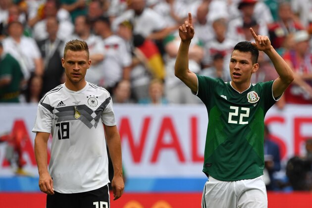 Mexico's forward Hirving Lozano (R) celebrates after scoring their first goal past Germany's defender Joshua Kimmich during the Russia 2018 World Cup Group F football match between Germany and Mexico at the Luzhniki Stadium in Moscow on June 17, 2018. (Photo by Yuri CORTEZ / AFP) / RESTRICTED TO EDITORIAL USE - NO MOBILE PUSH ALERTS/DOWNLOADS        (Photo credit should read YURI CORTEZ/AFP/Getty Images)
