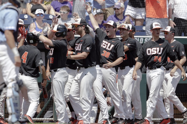Oregon State's Steven Kwan (4) is congratulated by teammates after he scored against North Carolina on a one-run triple by Trevor Larnach in the first inning of an NCAA College World Series baseball game in Omaha, Neb., Saturday, June 16, 2018. (AP Photo/Nati Harnik) Oregon State's Steven Kwan (4) is congratulated by teammates after he scored against North Carolina on a one-run triple by Trevor Larnach in the first inning of an NCAA College World Series baseball game in Omaha, Neb., Saturday, June 16, 2018. (AP Photo/Nati Harnik)