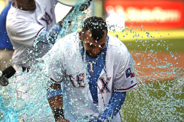 ARLINGTON, TX - JUNE 17: Jose Trevino #71 of the Texas Rangers is doused by teammates after he hit a game winning two-run single against the Colorado Rockies in the bottom of the ninth inning at Globe Life Park in Arlington on June 17, 2018 in Arlington, Texas. The Rangers won 13-12. (Photo by Ron Jenkins/Getty Images)