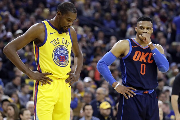 Golden State Warriors' Kevin Durant, left, stands next to Oklahoma City Thunder's Russell Westbrook during the first half of an NBA basketball game Saturday, Feb. 24, 2018, in Oakland, Calif. (AP Photo/Marcio Jose Sanchez)