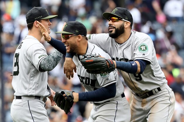 NEW YORK, NY - MAY 28:  J.D. Davis #28,George Springer #4 and Marwin Gonzalez #9 of the Houston Astros celebrate the win over the New York Yankees at Yankee Stadium on May 28, 2018 in the Bronx borough of New York City.MLB players across the league are wearing special uniforms to commemorate Memorial Day.The Houston Astros defeated the New York Yankees 5-1.  (Photo by Elsa/Getty Images)