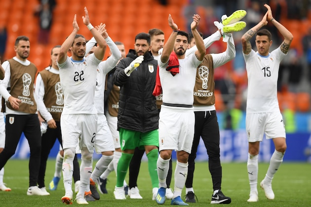Uruguay's forward Luis Suarez (C), Uruguay's defender Martin Caceres (L) and Uruguay's midfielder Matias Vecino (R) applaud after the final whistle of the Russia 2018 World Cup Group A football match between Egypt and Uruguay at the Ekaterinburg Arena in Ekaterinburg on June 15, 2018. (Photo by JORGE GUERRERO / AFP) / RESTRICTED TO EDITORIAL USE - NO MOBILE PUSH ALERTS/DOWNLOADS        (Photo credit should read JORGE GUERRERO/AFP/Getty Images)