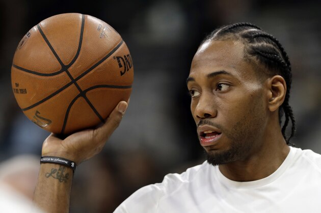FILE - In this Jan. 5, 2018, file photo, San Antonio Spurs forward Kawhi Leonard handles a ball before an NBA basketball game against the Phoenix Suns in San Antonio. A person familiar with the situation tells The Associated Press, Friday, June 15, 2018, that Leonard has told the Spurs that he would like to be traded this summer, the clearest sign yet that the relationship between the team and the All-Star is in disrepair. (AP Photo/Eric Gay, File)