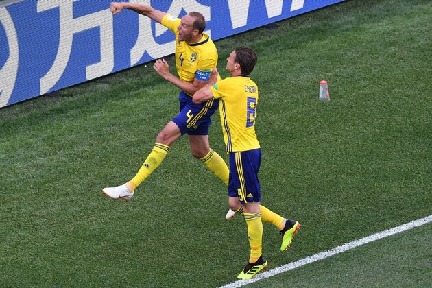 Sweden's defender Andreas Granqvist (L) celebrate after scoring a penalty during the Russia 2018 World Cup Group F football match between Sweden and South Korea at the Nizhny Novgorod Stadium in Nizhny Novgorod on June 18, 2018. (Photo by Dimitar DILKOFF / AFP) / RESTRICTED TO EDITORIAL USE - NO MOBILE PUSH ALERTS/DOWNLOADS        (Photo credit should read DIMITAR DILKOFF/AFP/Getty Images)