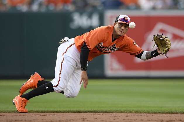 Baltimore Orioles shortstop Manny Machado (13) fields a ball that went for a single by Miami Marlins' JT Riddle during the ninth inning of a baseball game, Saturday, June 16, 2018, in Baltimore. (AP Photo/Nick Wass)