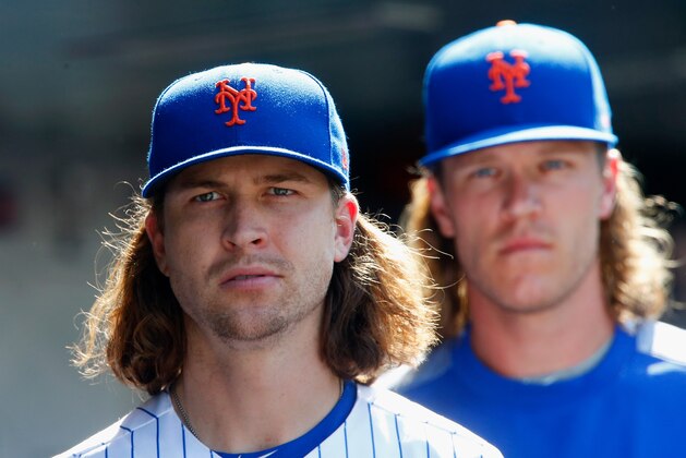 NEW YORK, NY - SEPTEMBER 04:  Jacob deGrom #48 (L) and Noah Syndergaard #34 of the New York Mets look on against the Philadelphia Phillies at Citi Field on September 4, 2017 in the Flushing neighborhood of the Queens borough of New York City. The Mets defeated the Phillies 11-7.  (Photo by Jim McIsaac/Getty Images)
