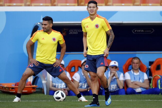 Colombia's James Rodriguez, right, and Colombia's Radamel Falcao, left, warm up during Colombia's official training on the eve of the group H match between Colombia and Japan at the 2018 soccer World Cup in the Mordavia Arena in Saransk, Russia, Monday, June 18, 2018. (AP Photo/Eugene Hoshiko)