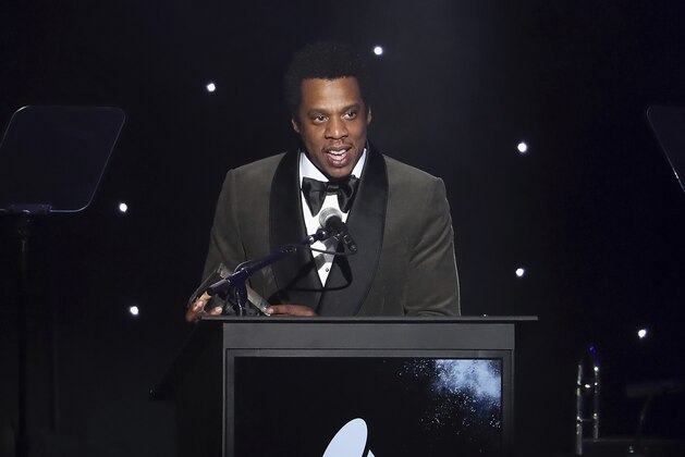FILE - In this Jan. 27, 2018, file photo, honoree Jay-Z speaks onstage at the 2018 Pre-Grammy Gala And Salute To Industry Icons at the Sheraton New York Times Square Hotel in New York. Jay-Z must explain why he's dodging a subpoena rather than answering questions related to a financial investigation of a consumer brand company that bought his Rocawear clothing line, a judge says. In an order made public Thursday, May 3, U.S. District Judge Paul G. Gardephe instructed the performer and entrepreneur, whose birth name is Shawn Carter, to appear in a New York courtroom next Tuesday to explain himself. (Photo by Michael Zorn/Invision/AP, File)