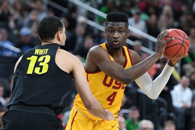 LAS VEGAS, NV - MARCH 09:  Paul White #13 of the Oregon Ducks guards Chimezie Metu #4 of the USC Trojans during a semifinal game of the Pac-12 basketball tournament at T-Mobile Arena on March 9, 2018 in Las Vegas, Nevada. The Trojans won 74-54.  (Photo by Ethan Miller/Getty Images)
