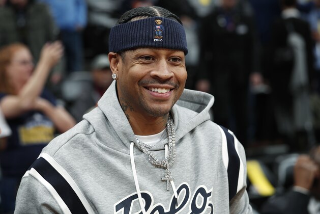 Retired Denver Nuggets guard Allen Iverson smiles as he jokes with fans before taking a seat to watch the Nuggets play the San Antonio Spurs in an NBA basketball game Friday, Feb. 23, 2018, in Denver. Iverson joined former teammates Kenyon Martin and Marcus Camby to be honored by the team during a ceremony at halftime. (AP Photo/David Zalubowski)