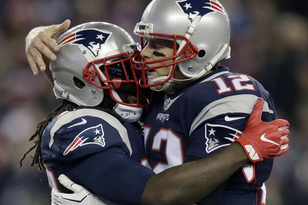 New England Patriots running back LeGarrette Blount, left, celebrates his touchdown run with quarterback Tom Brady during the first half of an NFL football game against the Baltimore Ravens, Monday, Dec. 12, 2016, in Foxborough, Mass. (AP Photo/Charles Krupa)