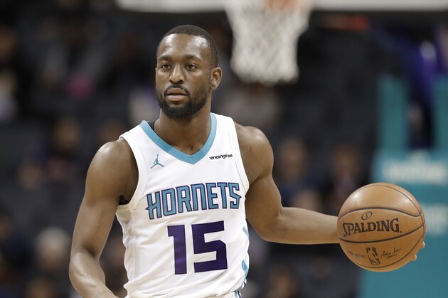 Charlotte Hornets' Kemba Walker (15) brings the ball up the court against the New York Knicks during the first half of an NBA basketball game in Charlotte, N.C., Monday, March 26, 2018. (AP Photo/Chuck Burton)