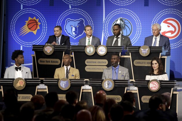 Eight NBA team representatives participating in the NBA basketball draft lottery sit on stage Tuesday, May 15, 2018, in Chicago. (AP Photo/Charles Rex Arbogast)