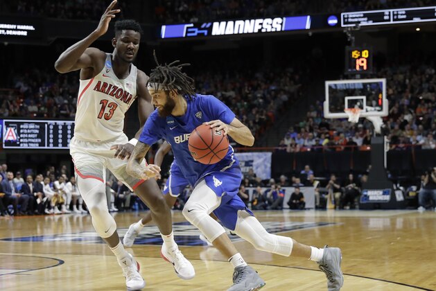 Buffalo guard Jeremy Harris, right, drives around Arizona forward Deandre Ayton (13) during the first half of a first-round game in the NCAA men's college basketball tournament Thursday, March 15, 2018, in Boise, Idaho. (AP Photo/Otto Kitsinger)