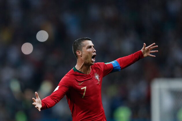 TOPSHOT - Portugal's forward Cristiano Ronaldo celebrates scoring his hat-trick during the Russia 2018 World Cup Group B football match between Portugal and Spain at the Fisht Stadium in Sochi on June 15, 2018. (Photo by Adrian DENNIS / AFP) / RESTRICTED TO EDITORIAL USE - NO MOBILE PUSH ALERTS/DOWNLOADS        (Photo credit should read ADRIAN DENNIS/AFP/Getty Images)