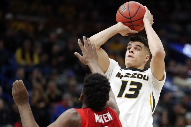 FILE - In this March 8, 2018, file photo, Missouri's Michael Porter Jr. (13) shoots over Georgia's Yante Maten during the first half in an NCAA college basketball game at the Southeastern Conference tournament, in St. Louis. Michael Porter Jr. played in three games in college because of back problems, but his talent has long been considered more than NBA-ready. He is the epitome of high-risk, high-reward in this draft. (AP Photo/Jeff Roberson, File)