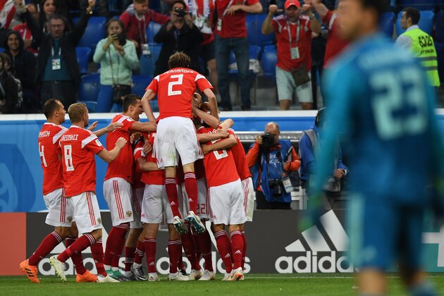 Russia's players celebrate after Egypt's defender Ahmed Fathi own goal during the Russia 2018 World Cup Group A football match between Russia and Egypt at the Saint Petersburg Stadium in Saint Petersburg on June 19, 2018. (Photo by Giuseppe CACACE / AFP) / RESTRICTED TO EDITORIAL USE - NO MOBILE PUSH ALERTS/DOWNLOADS        (Photo credit should read GIUSEPPE CACACE/AFP/Getty Images)