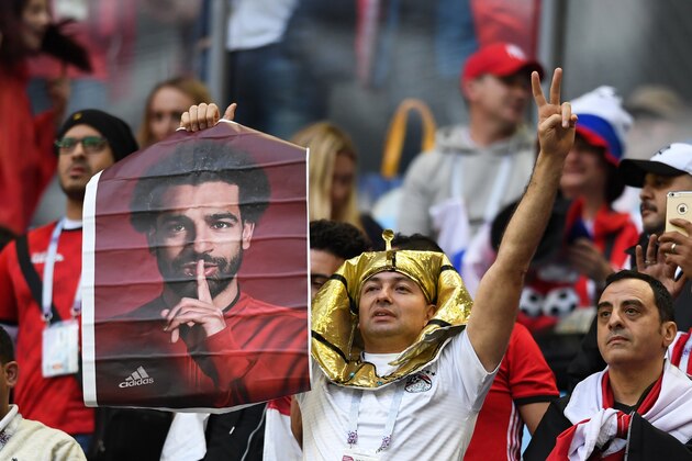 TOPSHOT - A Egypt's fan holds a poster showing Egypt's forward Mohamed Salah before the Russia 2018 World Cup Group A football match between Russia and Egypt at the Saint Petersburg Stadium in Saint Petersburg on June 19, 2018. (Photo by Giuseppe CACACE / AFP) / RESTRICTED TO EDITORIAL USE - NO MOBILE PUSH ALERTS/DOWNLOADS        (Photo credit should read GIUSEPPE CACACE/AFP/Getty Images)