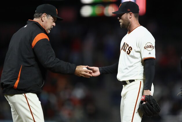 SAN FRANCISCO, CA - JUNE 18:  Manager Bruce Bochy takes out Hunter Strickland #60 of the San Francisco Giants after he gave up a hit to Miguel Rojas #19 of the Miami Marlins that scored the go-ahead run in the bottom of the ninth inning against the San Francisco Giants at AT&T Park on June 18, 2018 in San Francisco, California.  (Photo by Ezra Shaw/Getty Images)