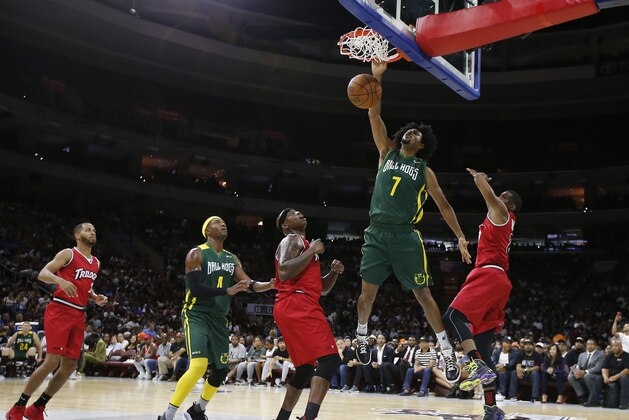 Ball Hogs' Josh Childress (7) dunks as Trilogy's Al Harrington and James White (8) defends during Game 2 in the BIG3 Basketball League in Philadelphia, Pa., Sunday, July 16, 2017. (AP Photo/Rich Schultz)