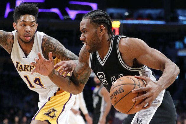 San Antonio Spurs' Kawhi Leonard, right, drives past Los Angeles Lakers' Brandon Ingram during the second half of an NBA basketball game, Sunday, Feb. 26, 2017, in Los Angeles. (AP Photo/Jae C. Hong)