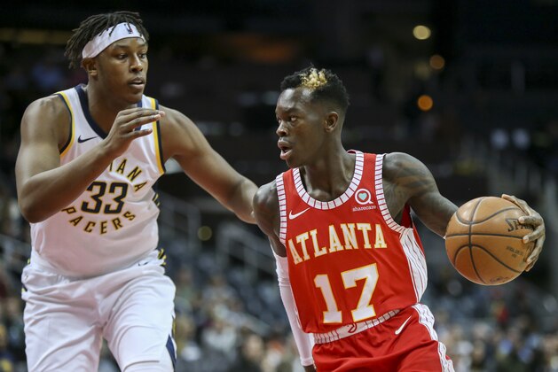 Indiana Pacers center Myles Turner (33) defends against Atlanta Hawks guard Dennis Schroeder (17) during the first half of an NBA basketball game Wednesday, Feb. 28, 2018, in Atlanta. (AP Photo/Brett Davis)