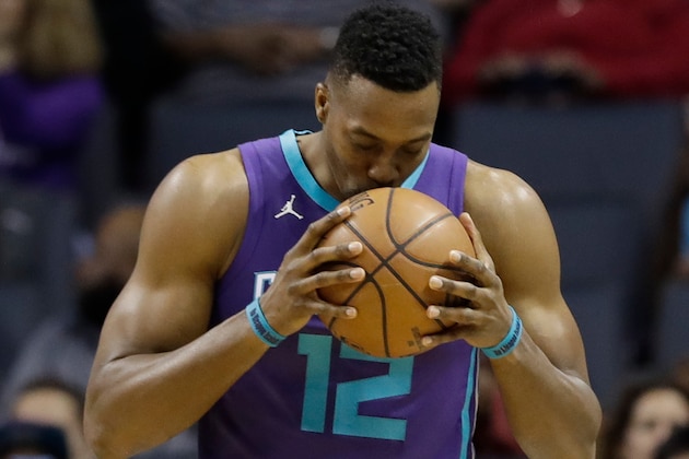 Charlotte Hornets' Dwight Howard (12) kisses the basketball before the start of an NBA basketball game against the Indiana Pacers in Charlotte, N.C., Sunday, April 8, 2018. (AP Photo/Chuck Burton)