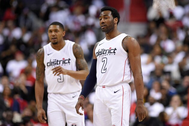 Washington Wizards guard John Wall (2) stands in front of Bradley Beal (3) during the second half of Game 3 of an NBA basketball first-round playoff series against the Toronto Raptors, Friday, April 20, 2018, in Washington. The Wizards won 122-103. (AP Photo/Nick Wass)