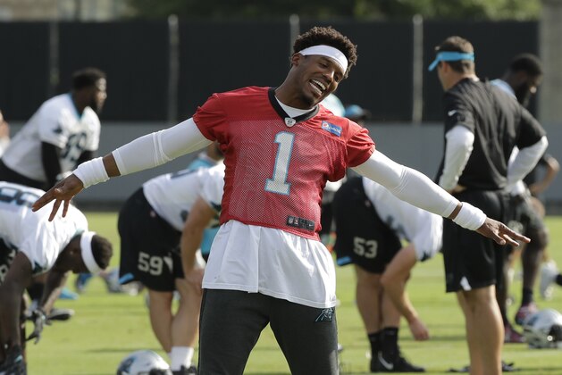 Carolina Panthers' Cam Newton (1) jokes with coaches and players during the NFL football team's practice in Charlotte, N.C., Thursday, June 14, 2018. (AP Photo/Chuck Burton)