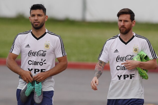 Lionel Messi, right, and Sergio Aguero arrive for a training session of Argentina at the 2018 soccer World Cup in Bronnitsy, Russia, Tuesday, June 19, 2018. (AP Photo/Ricardo Mazalan)