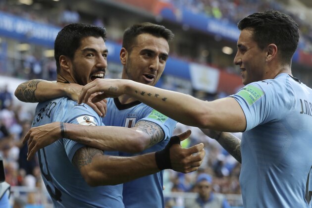Uruguay's Luis Suarez , left, is greeted by teammates after scoring his team's opening goal during the group A match against Saudi Arabia at the 2018 soccer World Cup in Rostov Arena in Rostov-on-Don, Russia, Wednesday, June 20, 2018. (AP Photo/Andrew Medichini) Uruguay's Luis Suarez , left, is greeted by teammates after scoring his team's opening goal during the group A match against Saudi Arabia at the 2018 soccer World Cup in Rostov Arena in Rostov-on-Don, Russia, Wednesday, June 20, 2018. (AP Photo/Andrew Medichini)