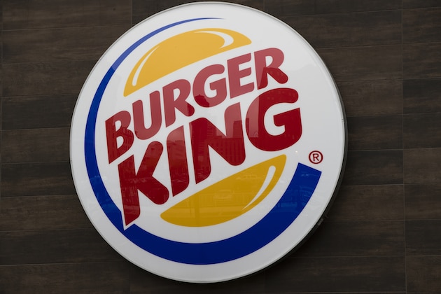FILE - This Oct. 21, 2016, file photo shows a Burger King restaurant logo in Philadelphia. Burger King has delivered its own hot take on a regulatory showdown that has enflamed the U.S., with a flame-grilled Whopper. The new ad has become a sensation, with more than a million views and counting on YouTube. In the ad, customers are told they will be charged different prices for a Whopper, depending on how fast they want it. (AP Photo/Matt Rourke, File)