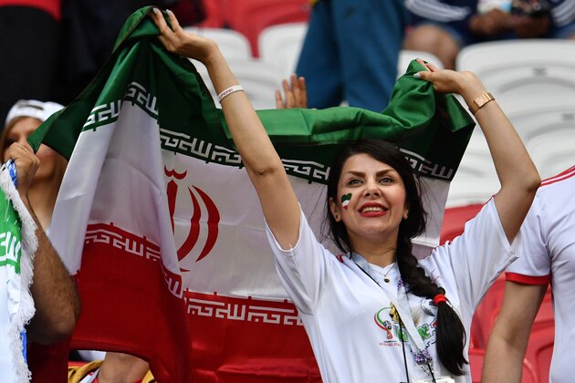 An Iranian supporter poses with the national flag ahead of the Russia 2018 World Cup Group B football match between Iran and Spain at the Kazan Arena in Kazan on June 20, 2018. (Photo by SAEED KHAN / AFP) / RESTRICTED TO EDITORIAL USE - NO MOBILE PUSH ALERTS/DOWNLOADS        (Photo credit should read SAEED KHAN/AFP/Getty Images)