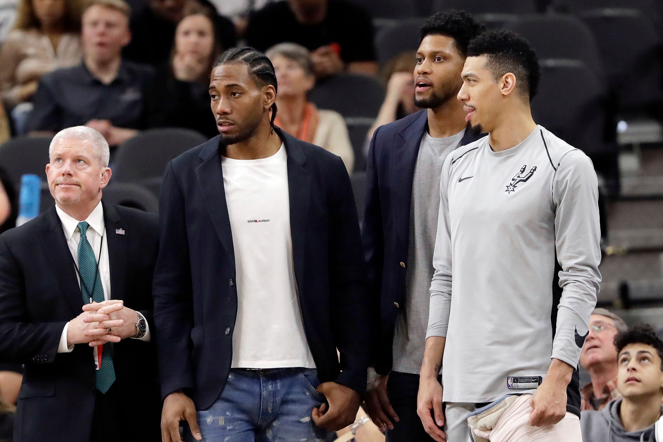 FILE - In this Jan. 21, 2018, file photo, San Antonio Spurs guard Danny Green, right, stands at the bench with injured teammates Kawhi Leonard, second from left, and Rudy Gay, center, during the second half of an NBA basketball game against the Indiana Pacers in San Antonio. The absolute unwillingness to answer certain questions is part of the San Antonio Spurs' mystique. The Spurs just don't share much. So there is some unmistakable irony here that when it comes to the obviously fractured relationship between San Antonio and Kawhi Leonard, it's the Spurs who are the ones frustrated by the lack of answers. (AP Photo/Eric Gay, File)