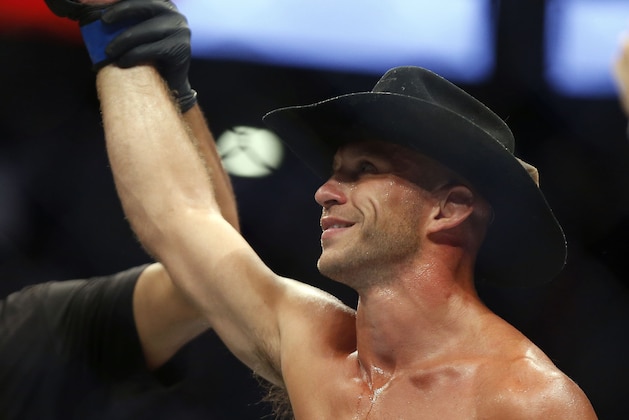 Donald Cerrone raises his hand after defeating Rick Story in a welterweight mixed martial arts bout at UFC 202 on Saturday, Aug. 20, 2016, in Las Vegas. (AP Photo/Isaac Brekken)