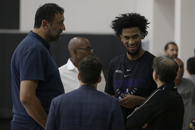 Forward Marvin Bagley III, second from right, talks with Sacramento Kings owner Vivek Randive, right, as Vlade Divac, the Kings general manager, left, looks on after he worked out for the basketball team Monday, June 11, 2018, in Sacramento, Calif. The Kings have the second pick in the upcoming NBA draft and the former Duke star is considered one of the top choices in the draft. (AP Photo/Rich Pedroncelli)