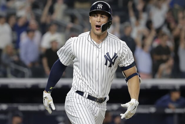 New York Yankees' Giancarlo Stanton reacts after hitting a walk-off two-run home run during the ninth inning of a baseball game against the Seattle Mariners at Yankee Stadium Wednesday, June 20, 2018, in New York. The Yankees defeated the Mariners 7-5. (AP Photo/Seth Wenig)