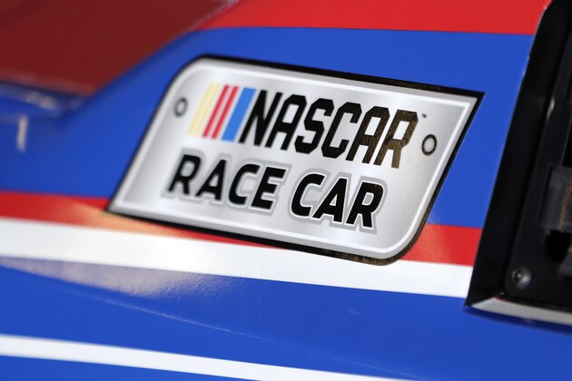 A NASCAR logo on a car is seen in the garage during a NASCAR auto racing practice session at Daytona International Speedway, Saturday, Feb. 10, 2018, in Daytona Beach, Fla. (AP Photo/John Raoux)