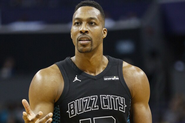 Charlotte Hornets center Dwight Howard argues with a referee as Charlotte plays the Philadelphia 76ers in the second half of an NBA basketball game in Charlotte, N.C., on Sunday, April 1, 2018. Philadelphia won 119-102. (AP Photo/Nell Redmond)