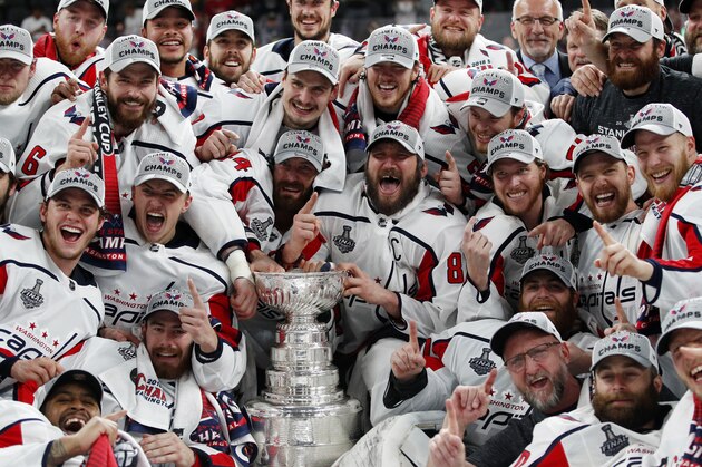 Members of the Washington Capitals pose with the Stanley Cup after the Capitals defeated the Golden Knights 4-3 in Game 5 of the NHL hockey Stanley Cup Finals Thursday, June 7, 2018, in Las Vegas. (AP Photo/John Locher)