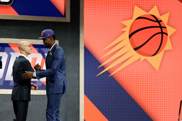 BROOKLYN, NY - JUNE 21:  NBA Commissioner Adam Silver shakes hands with DeAndre Ayton after DeAndre was selected number one overall by the Phoenix Suns on June 21, 2018 at Barclays Center during the 2018 NBA Draft in Brooklyn, New York.  NOTE TO USER: User expressly acknowledges and agrees that, by downloading and or using this photograph, User is consenting to the terms and conditions of the Getty Images License Agreement. Mandatory Copyright Notice: Copyright 2018 NBAE (Photo by Chris Marion/NBAE via Getty Images)