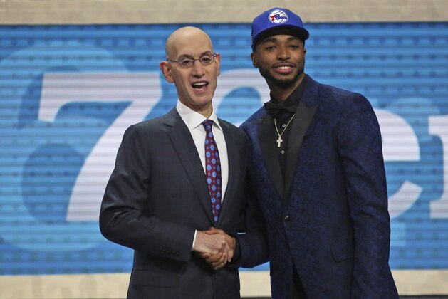 Villanova's Mikal Bridges, right, poses with NBA Commissioner Adam Silver after he was picked 10th overall by the Philadelphia 76ers during the NBA basketball draft in New York, Thursday, June 21, 2018. (AP Photo/Kevin Hagen)