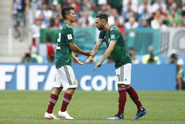 Mexico's Hirving Lozano, left, is substituted bu Mexico's Miguel Layun during the group F match between Germany and Mexico at the 2018 soccer World Cup in the Luzhniki Stadium in Moscow, Russia, Sunday, June 17, 2018. (AP Photo/Matthias Schrader)