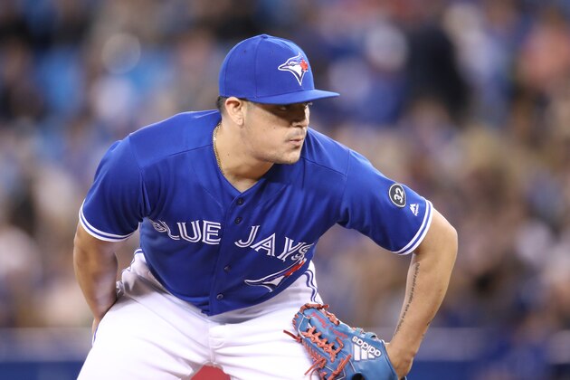 TORONTO, ON - APRIL 28: Roberto Osuna #54 of the Toronto Blue Jays looks in before delivering a pitch in the ninth inning during MLB game action against the Texas Rangers at Rogers Centre on April 28, 2018 in Toronto, Canada. (Photo by Tom Szczerbowski/Getty Images) *** Local Caption *** Roberto Osuna