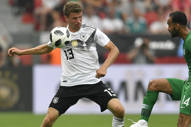 Germany's Thomas Muller, left, duels for the ball with Saudi Arabia's Abdullah Otayf during a friendly soccer match between Germany and Saudi Arabia at BayArena in Leverkusen, Germany, Friday, June 8, 2018. (AP Photo/Martin Meissner)