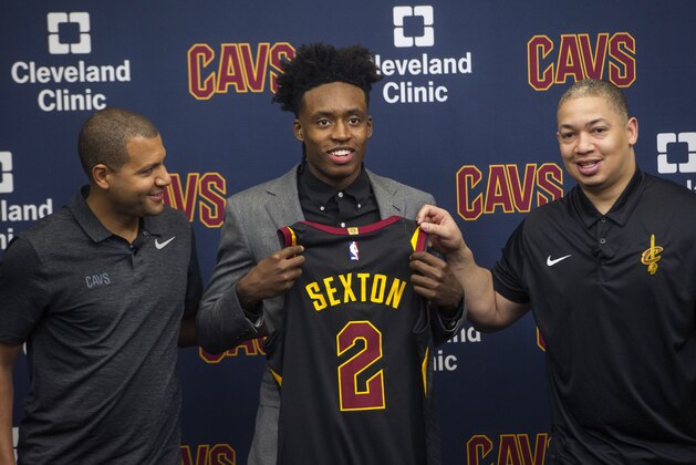 Cleveland Cavaliers first round draft selection, Collin Sexton, center, displays his jersey with Cavaliers general manager Koby Altman, left and Cavaliers head coach Tyronn Lue during a news conference at the Cavaliers training facility in Independence, Ohio, Friday, June 22, 2018.  (AP Photo/Phil Long)