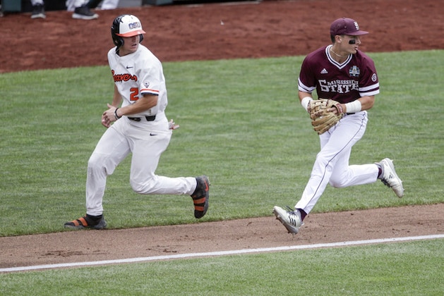 Mississippi State third baseman Justin Foscue, looks toward second base after tagging out Oregon State's Cadyn Grenier (2) in a rundown between third base and home in the first inning of an NCAA College World Series baseball game in Omaha, Neb., Friday, June 22, 2018. (AP Photo/Nati Harnik) right, Mississippi State third baseman Justin Foscue, looks toward second base after tagging out Oregon State's Cadyn Grenier (2) in a rundown between third base and home in the first inning of an NCAA College World Series baseball game in Omaha, Neb., Friday, June 22, 2018. (AP Photo/Nati Harnik) right,
