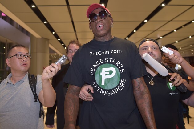 TOPSHOT - Retired American professional basketball player Dennis Rodman speaks to the press as he arrives at Changi International airport ahead of US-North Korea summit in Singapore on June 11, 2018. - North Korea's  Kim Jong Un and US President Donald Trump meet on June 12 for an unprecedented summit in an attempt to address the last festering legacy of the Cold War, with the US President calling it a 'one time shot' at peace. (Photo by ADEK BERRY / AFP)        (Photo credit should read ADEK BERRY/AFP/Getty Images)