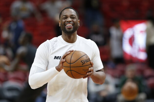 Miami Heat guard Dwyane Wade smiles as he warms up for the team's NBA basketball game against the Milwaukee Bucks, Friday, Feb. 9, 2018, in Miami. Wade was traded back to the Heat from the Cleveland Cavaliers on Thursday. (AP Photo/Wilfredo Lee)